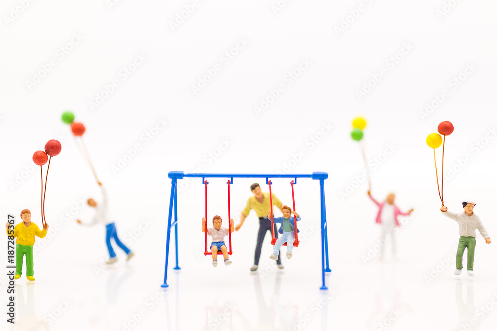 Miniature people : father swing cradle with children, and childrens play balloon together wiht fun, using as background International day of families concept. Miniature people : father swing cradle with children, and childrens play balloon together wiht fun, using as background International day of families concept.