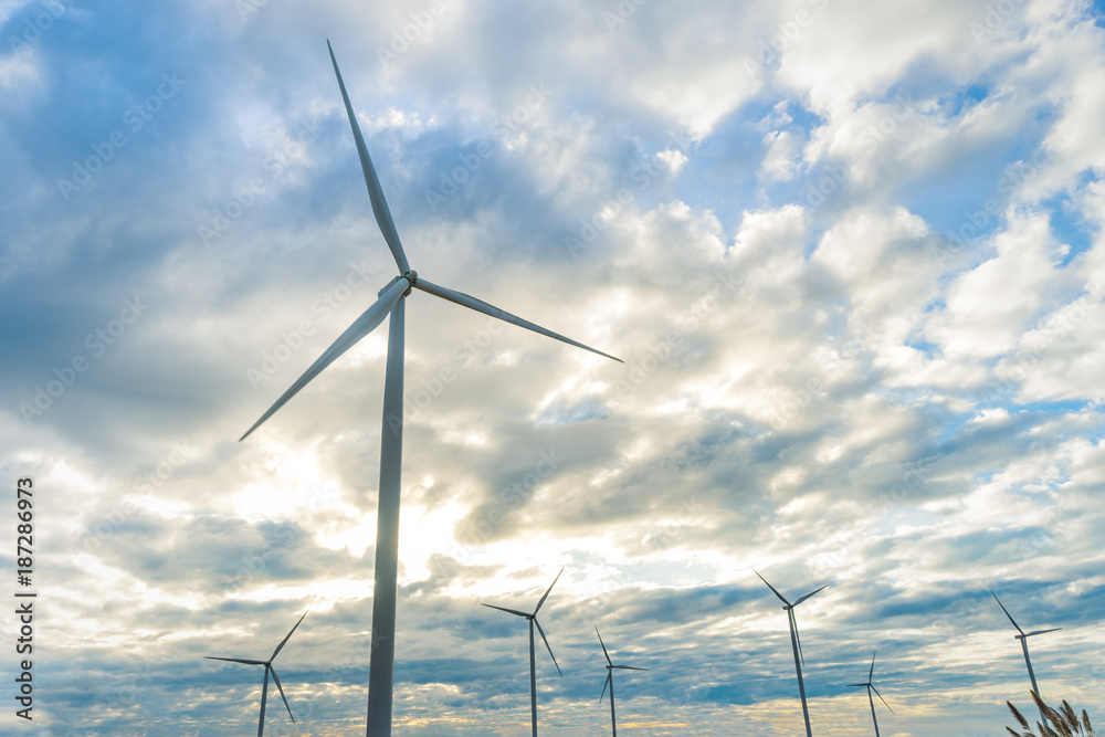 Wind Turbines in Wind Farm with Cloudy Blue Sky at Khao Kho District of Phetchabun Province, Thailand. Wind Turbines in Wind Farm with Cloudy Blue Sky at Khao Kho District of Phetchabun Province, Thailand.
