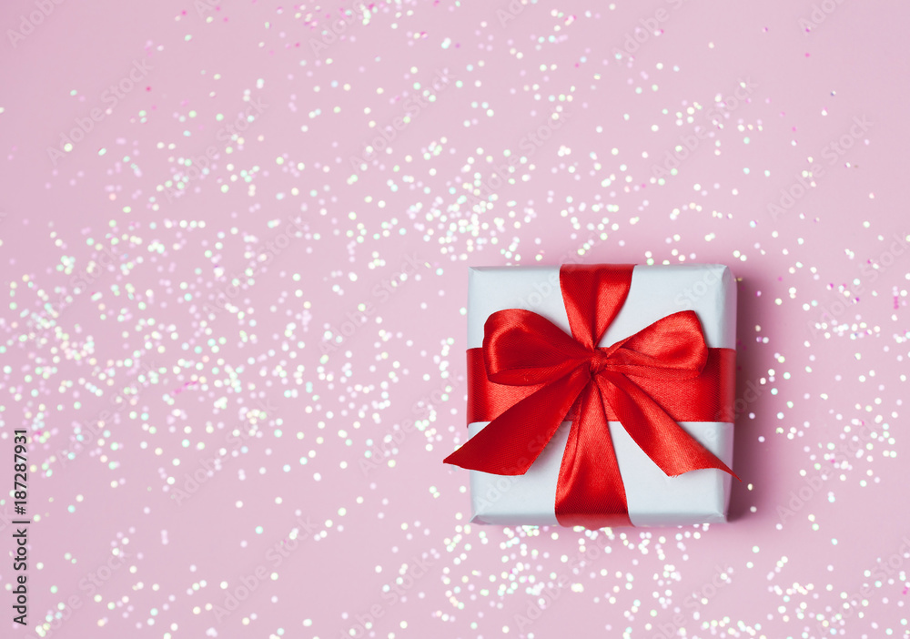 gift box vith red bow and glitter sparkles on pink background. st. Valentine's day concept gift box vith red bow and glitter sparkles on pink background. st. Valentine's day concept