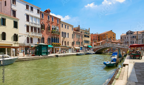 Venice, Italy - August 14, 2017: Venice canal with boats and classic buildings.