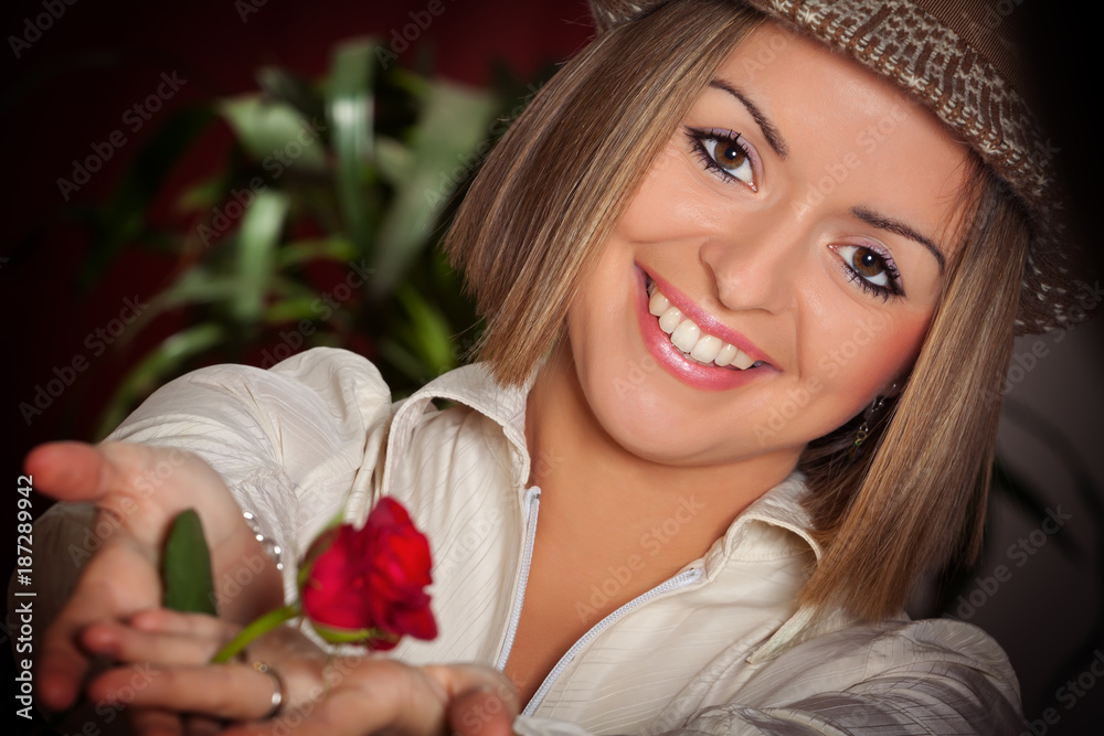 Close-up portrait of young beautiful woman with red rose Close-up portrait of young beautiful woman with red rose