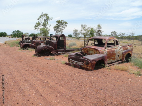 Western Australia-November 8, 2010: Three rusting scrapped road vehicles in the outback.