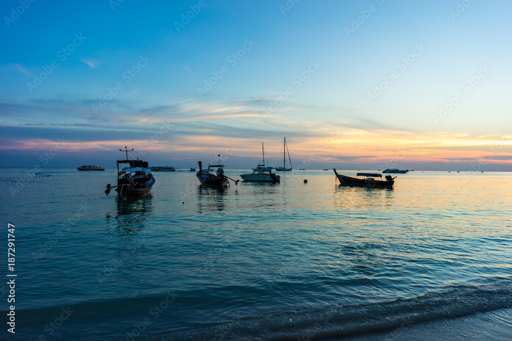 Fishing boat and sunset sky on Pattaya beach, Koh Lipe, Satoon province, Thailand.