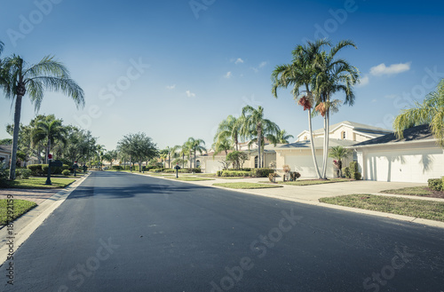 Gated community houses and empty asphalt road,  South Florida, United States © marchello74