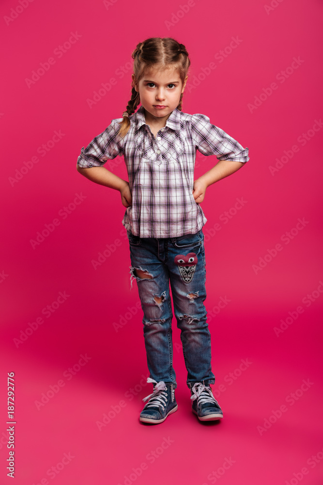 Serious little girl child standing isolated Serious little girl child standing isolated
