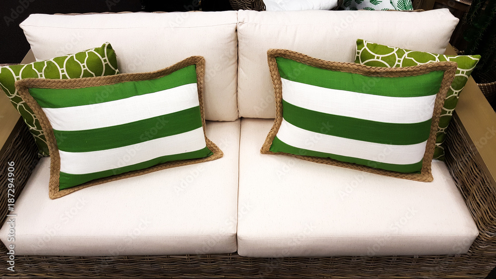Green and white cushions on a sofa as styled by interior designer Green and white cushions on a sofa as styled by interior designer