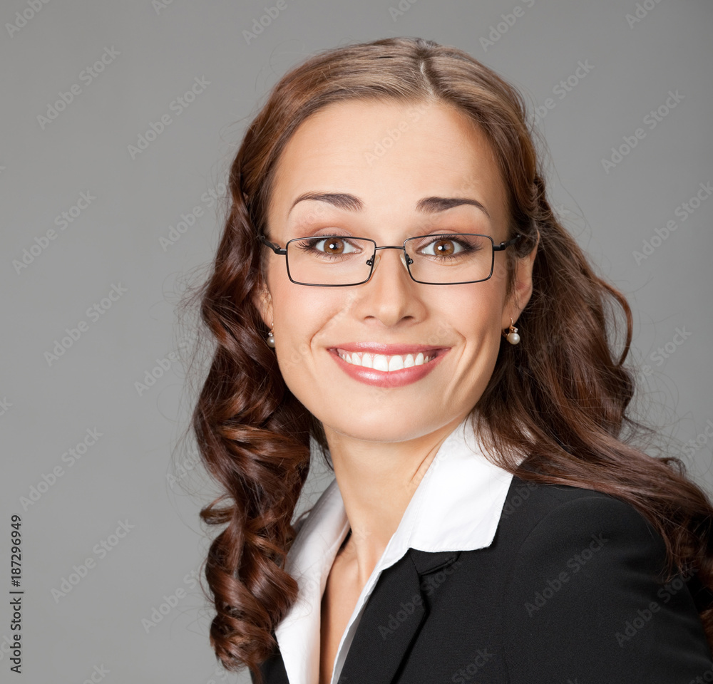 Smiling businesswoman, over gray Smiling businesswoman, over gray