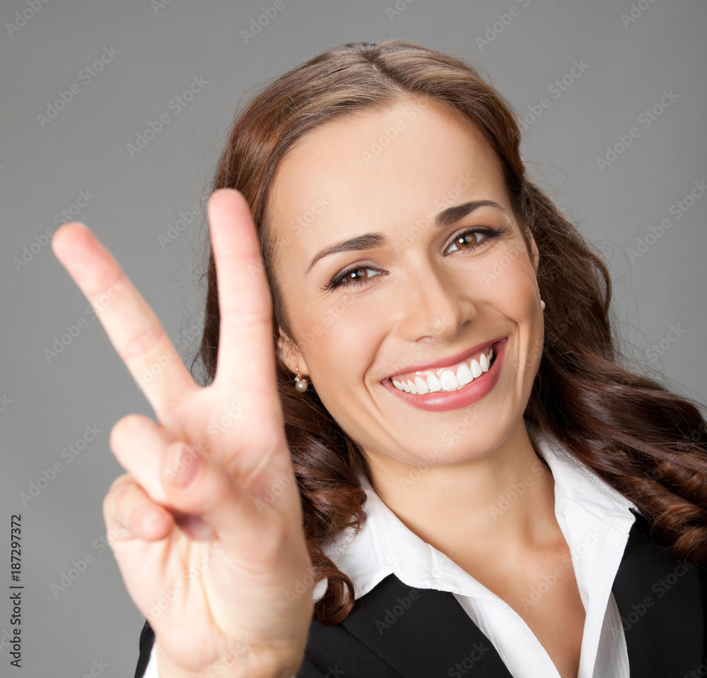 Businesswoman showing two fingers or victory gesture Businesswoman showing two fingers or victory gesture