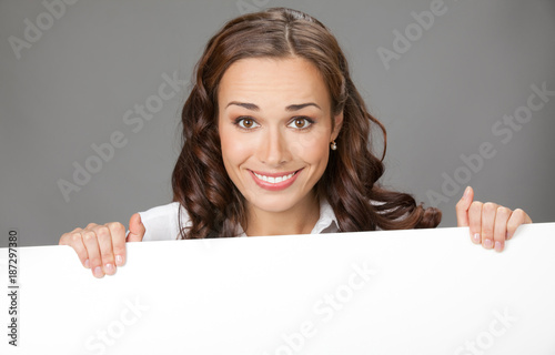 Businesswoman showing signboard, over grey