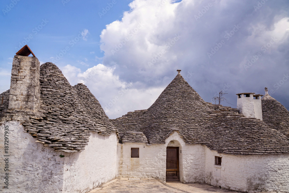 Beautiful white houses of Alberobello twon in Italy with their specific conical stone shingle roofs