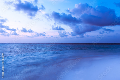 Wallpaper Mural Tropical island at dawn. Beautiful bright sunrise over a tropical beach. Ocean and white sand. Clouds of gentle color over the sea. Torontodigital.ca
