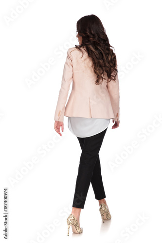 back view of a businesswoman walking and looking to side