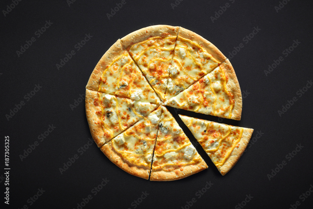 Pizza with cheese feta parmesan mozzarella dor blu on a black stone background