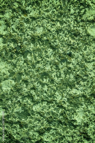Green Granite rock closeup background, stone texture, cracked surface