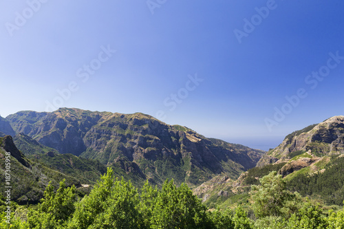 Wide angle view of mountains and valleys in the late morning on the island of Madeira in Portugal.