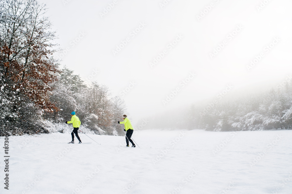 Senior couple cross-country skiing.