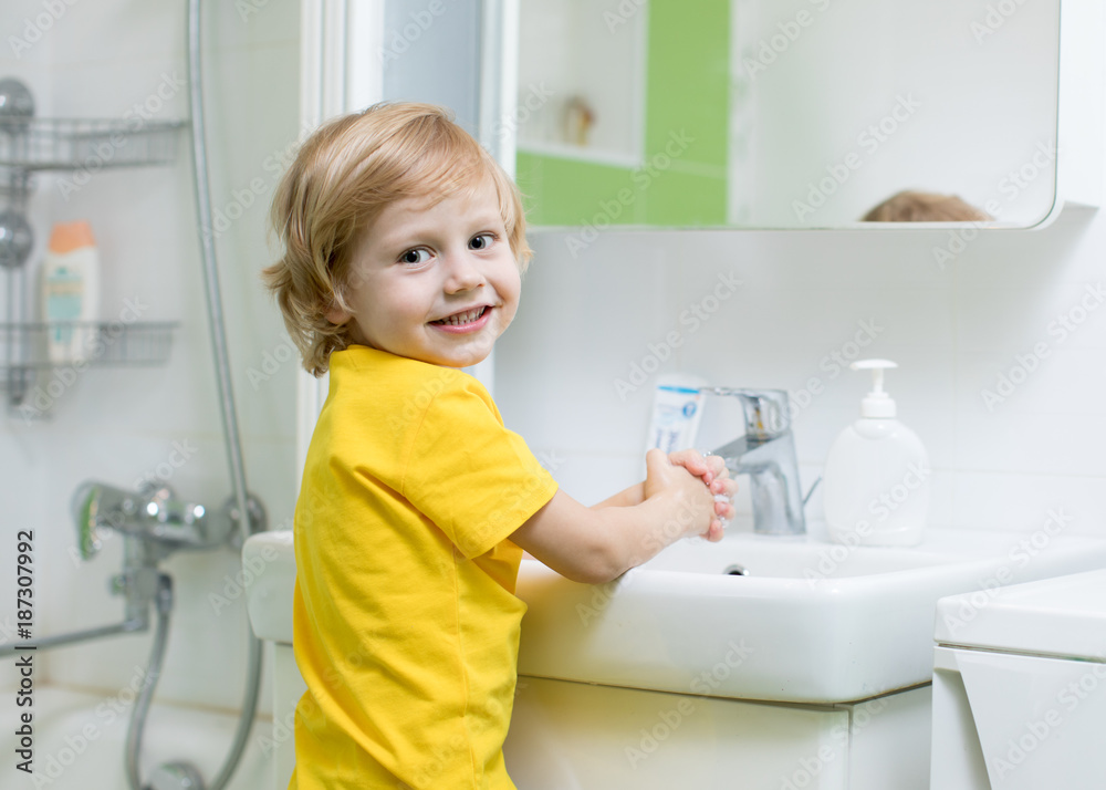 Little child boy washing hands