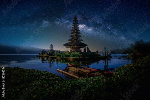Pura Ulun Danu Bratan, Hindu temple with boat on Bratan lake landscape with milky way in Bali, Indonesia.