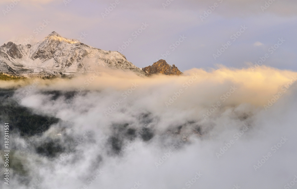 peak of mountain in the clouds at sunset 