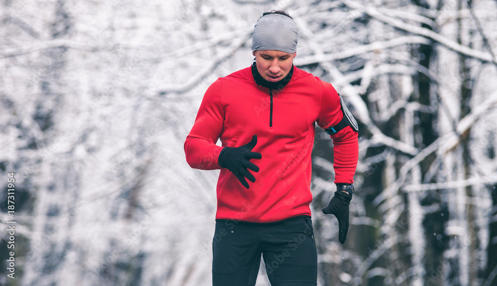 Winter running training, runner at cold snow weather Winter running training, runner at cold snow weather