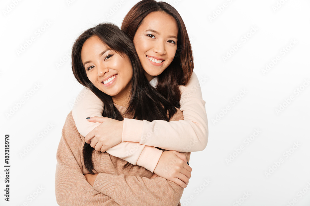 Two asian pretty cheerful ladies sisters Two asian pretty cheerful ladies sisters
