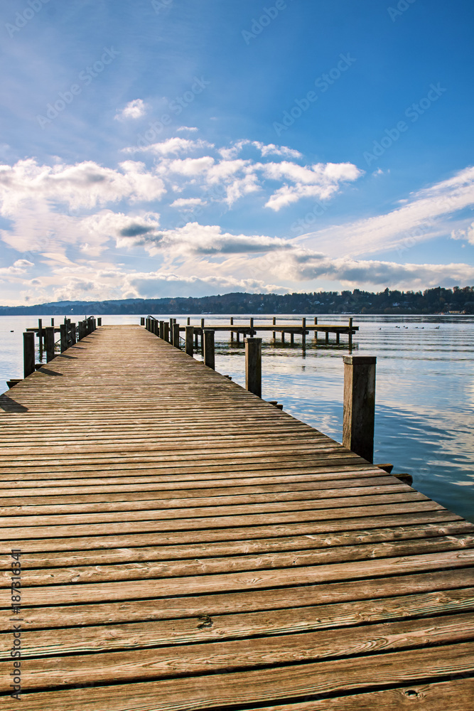 Fototapeta premium Empty wooden pier on Lake Starnberg in Bavaria, Germany