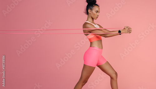 Sportswoman exercising with resistance band