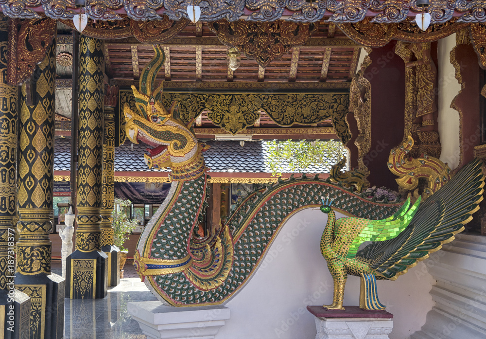 Fototapeta premium Dragon and peacock statues at a Buddhist temple near Chiang Mai