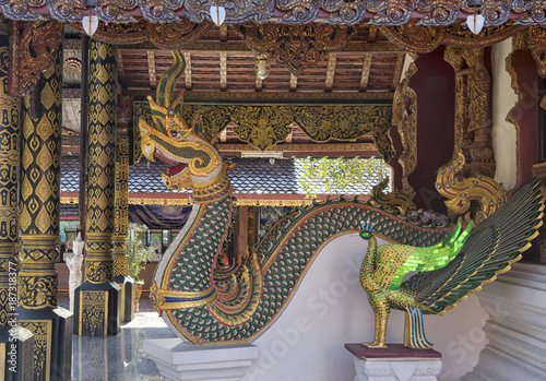 Dragon and peacock statues at a Buddhist temple near Chiang Mai