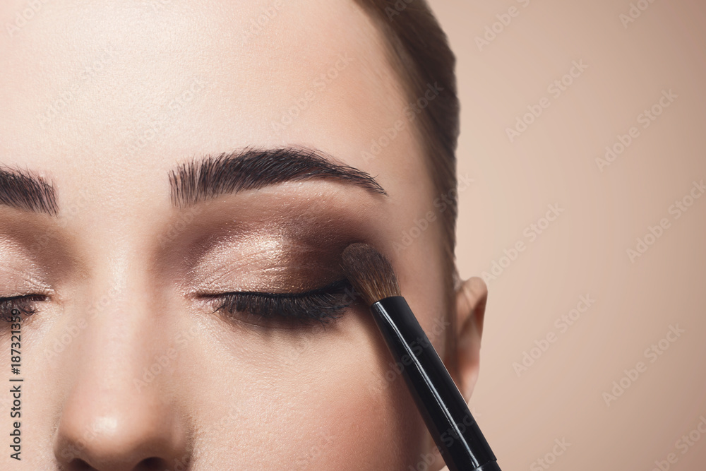 Make-up artist apply eyeshadow with brush, beauty