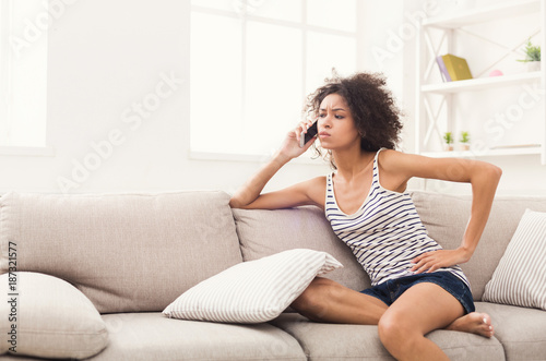 Thoughtful young girl calling on mobile phone