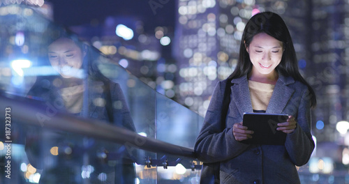 Photography Woman uses a tablet computer at night