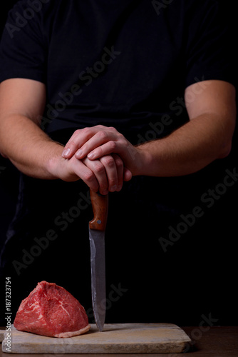 Butcher with knife and raw beef
