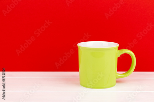 green cup with red background