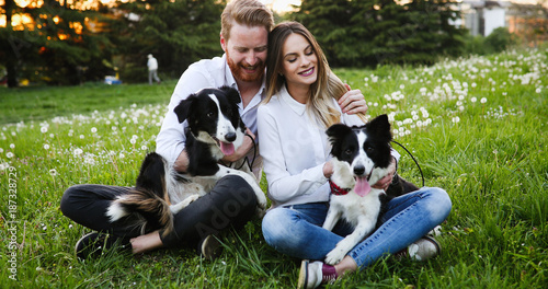 Beautiful couple walking dogs and bonding in nature