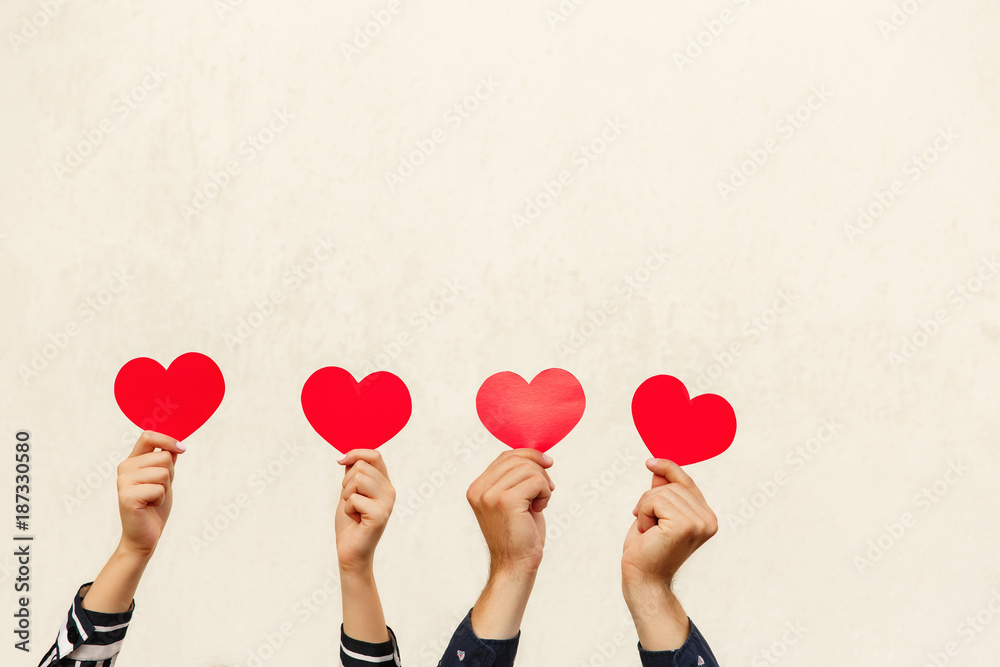 Hands with red hearts. Couple in love. Valentines day concept. Red heart - symbol of love Hands with red hearts. Couple in love. Valentines day concept. Red heart - symbol of love