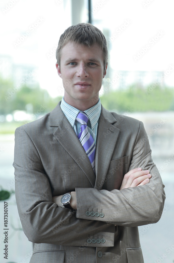 Portrait of happy businessman standing in office Portrait of happy businessman standing in office