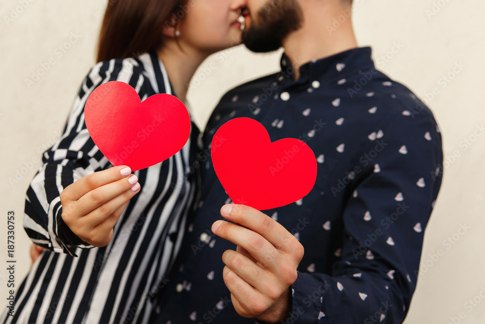Love background. Couple on love with two red hearts. Kiss at first date at valentines day. Marriage proposal Love background. Couple on love with two red hearts. Kiss at first date at valentines day. Marriage proposal