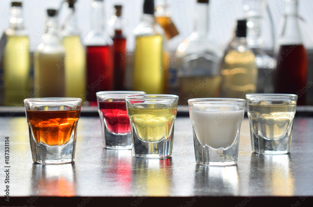Selection of alcoholic drinks. Set of wine, brandy, liqueur, tincture, cognac, whiskey in glasses, bottles. Large variety of alcohol and spirits for making cocktails and drink. Copy space for text Selection of alcoholic drinks. Set of wine, brandy, liqueur, tincture, cognac, whiskey in glasses, bottles. Large variety of alcohol and spirits for making cocktails and drink. Copy space for text