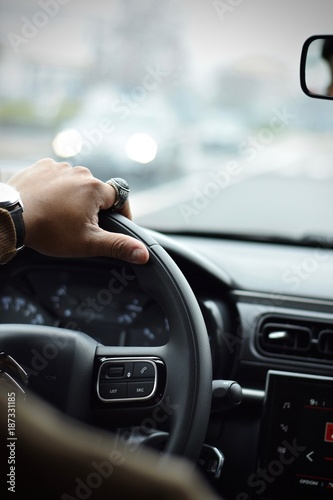 Man hand close up driving a car