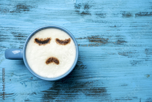 Obraz na plátně cup of cappuccino with a sad face