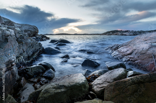 Small bay in Helleviga recreation area, rocks and stones in the ocean, blue hour in South Norway