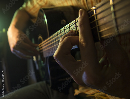 Musician man is playing the guitar photo