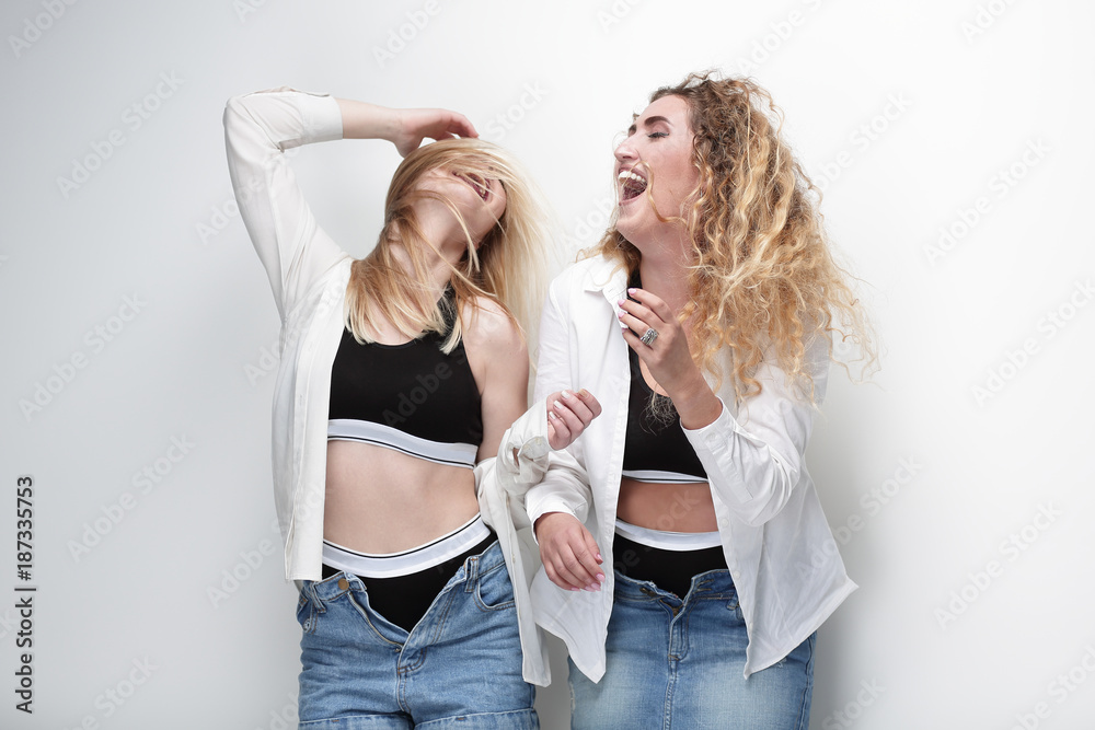 two young female models standing next to each other two young female models standing next to each other