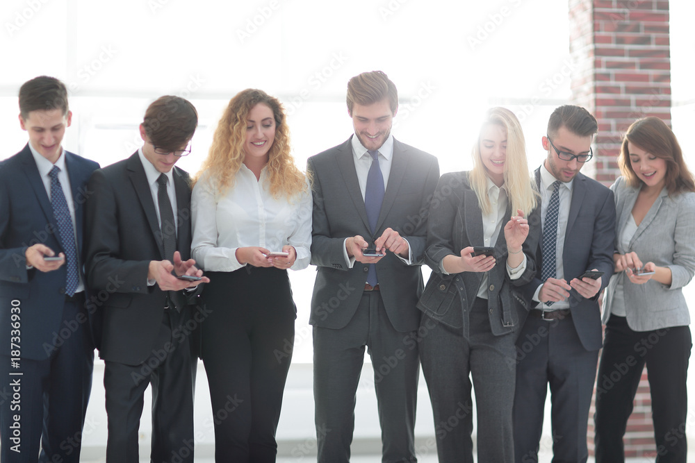 business team looking to smartphone in office business team looking to smartphone in office