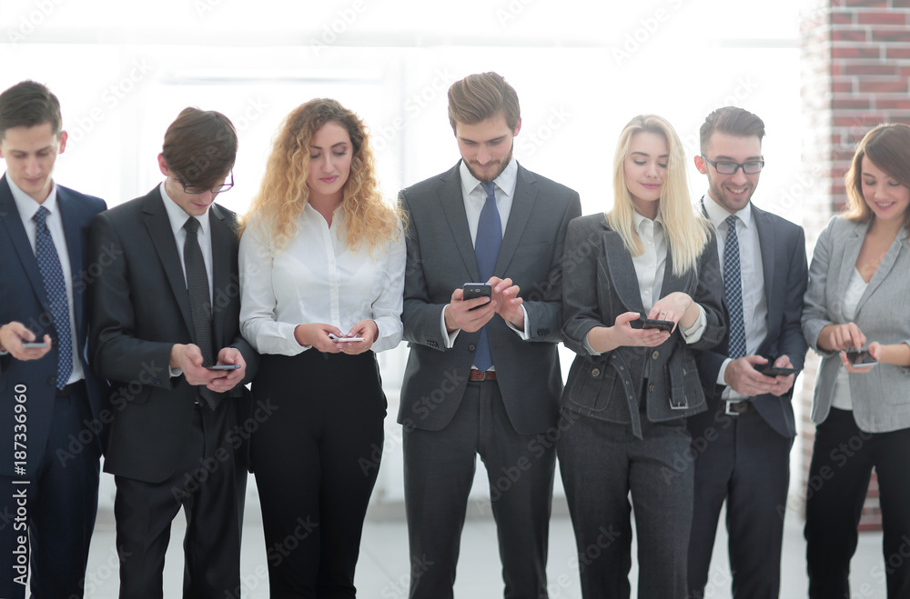 business team looking to smartphone in office business team looking to smartphone in office
