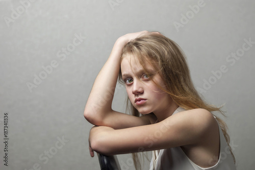 portrait teenager girl on a gray background