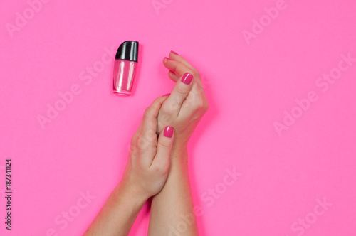 Nail salon. Beautiful female hands with pink nail polish