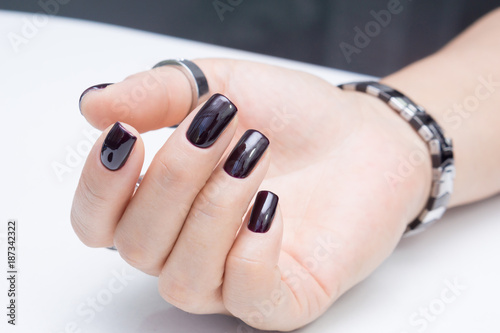 Attractive manicure on women's hands. Natural finger nails with stylish nail art.