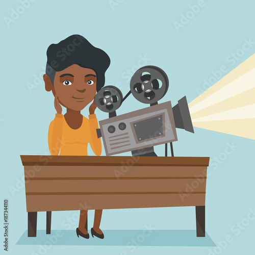 African-american projectionist sitting at the table with film projector. Young projectionist showing a new film. Vector cartoon illustration. Square layout.